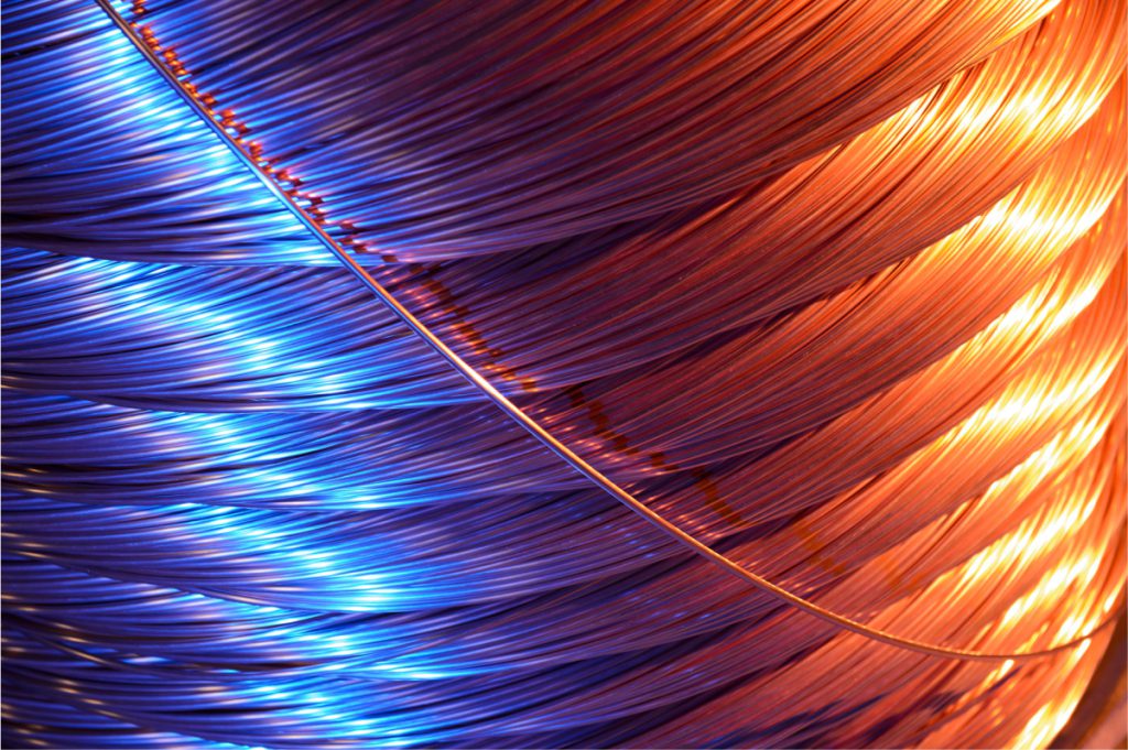 Copper magnet wire wound on a spool for electrical and industrial use.