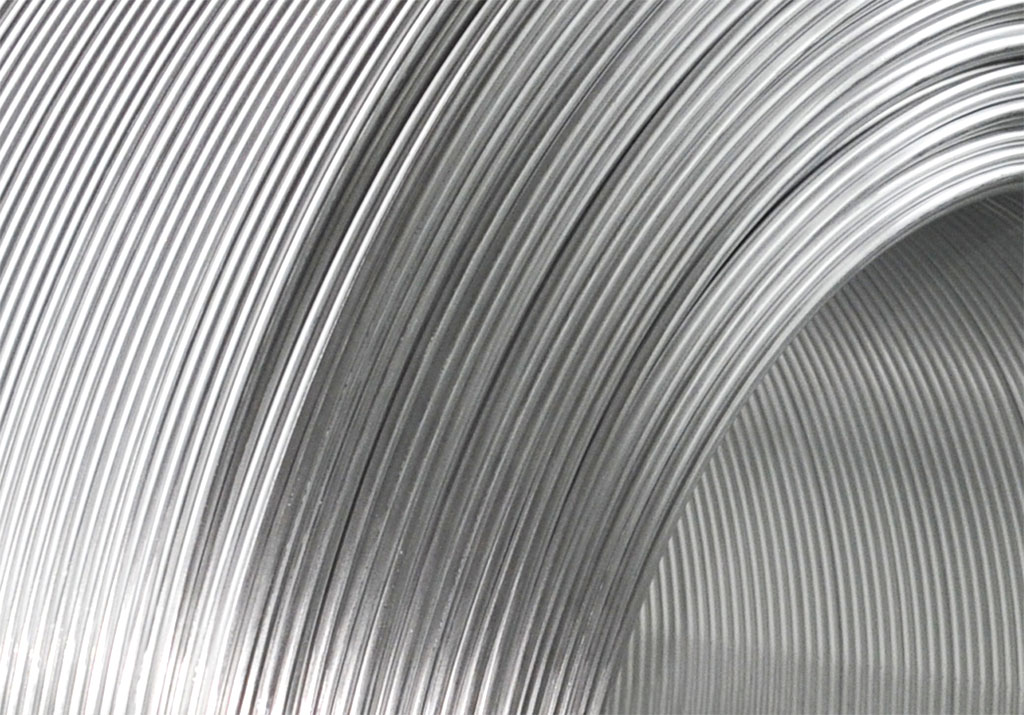 Aluminum wire coiled for use in electrical and manufacturing applications.